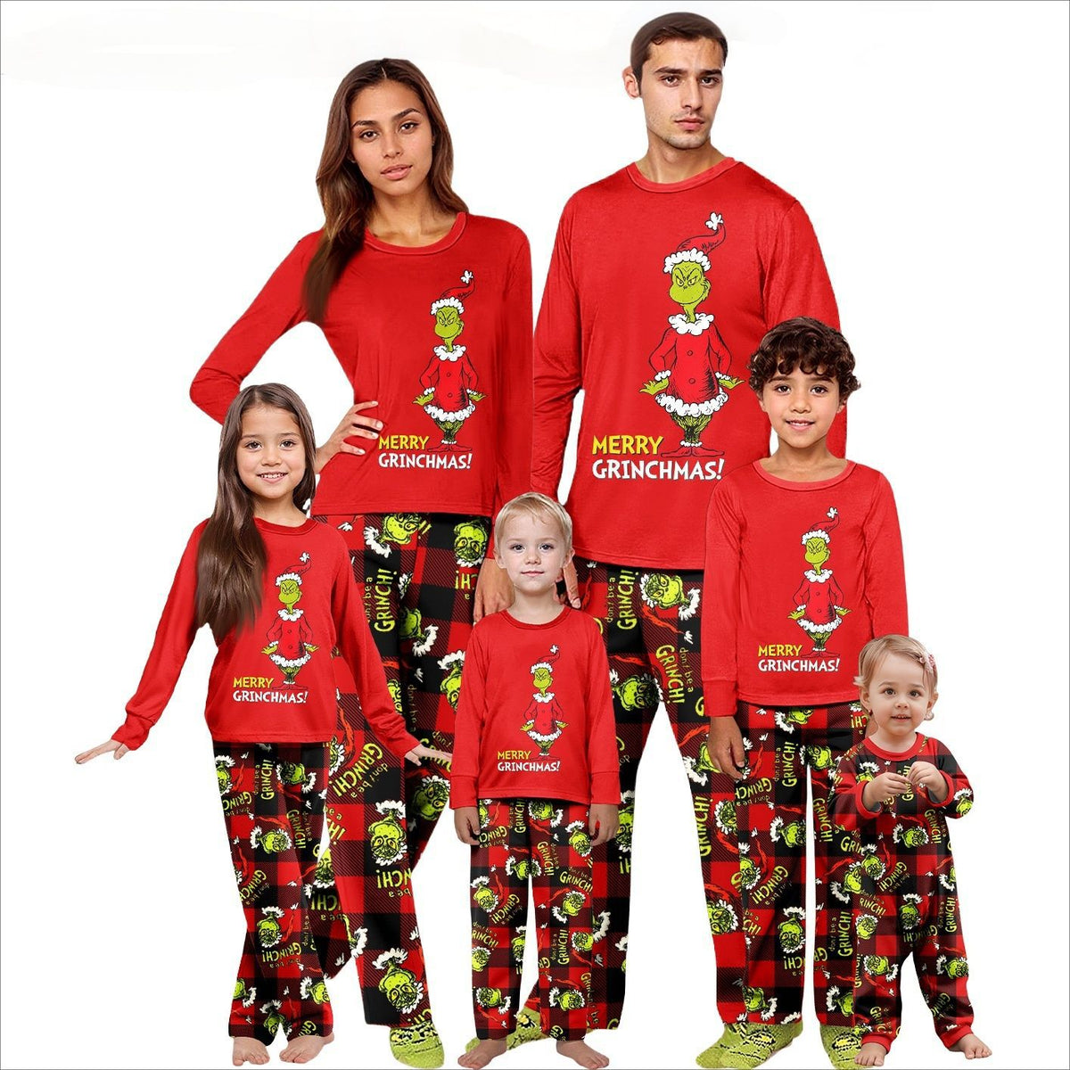 Family models wearing red Grinch pajama sets and a matching plaid baby romper on a white background