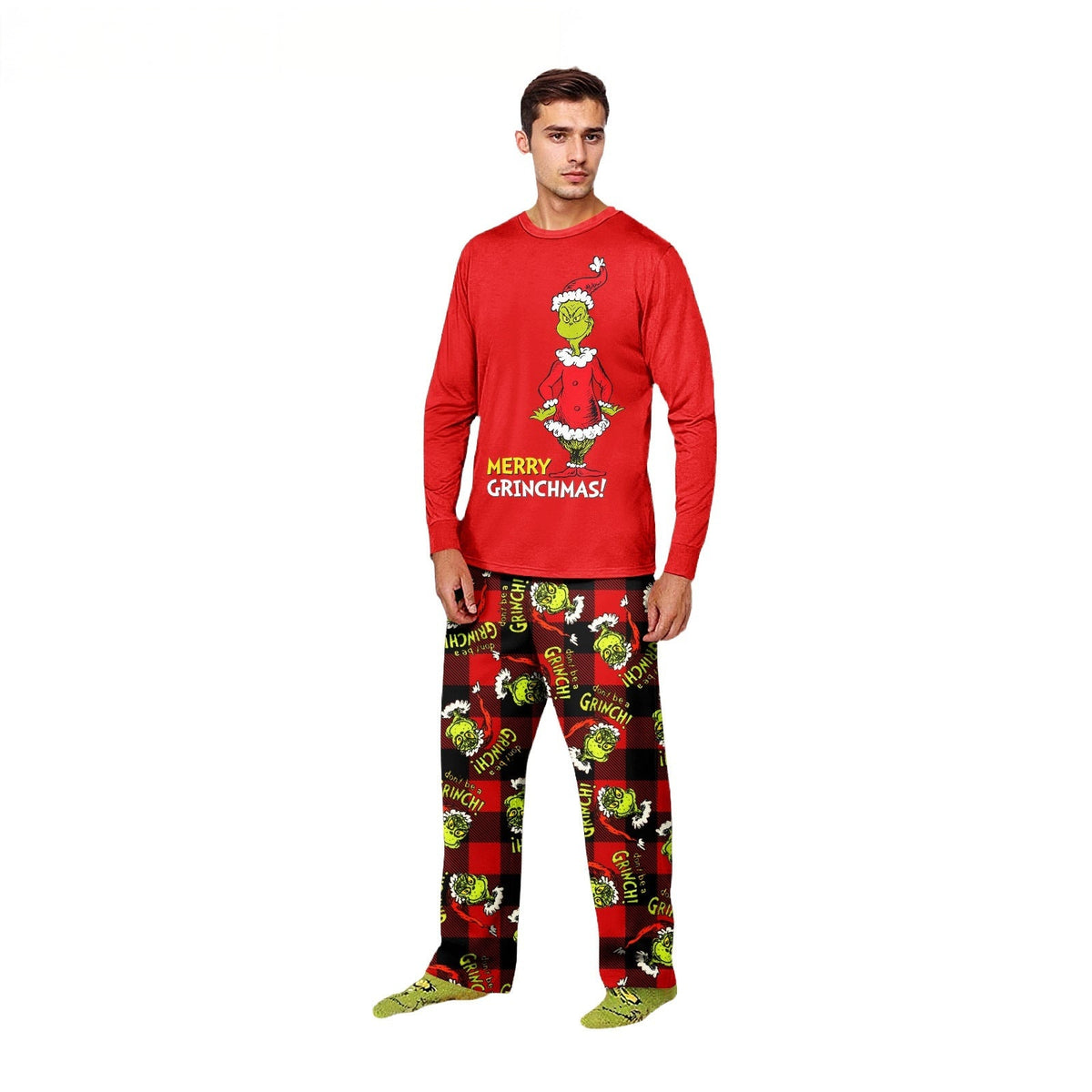 Man wearing a red Grinch Christmas top and red-and-black plaid character-print pajama pants