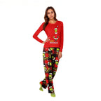 Woman wearing a red Merry Grinchmas top and red-and-black plaid pajama pants with character prints