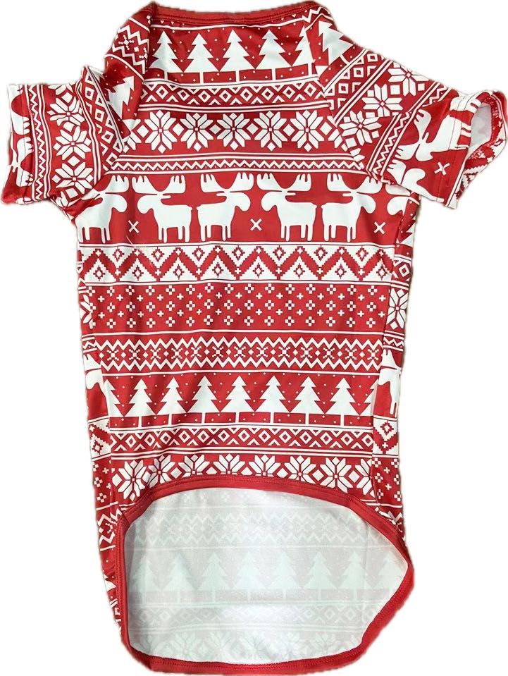 Red dog pajama shirt with white reindeer, Christmas trees and snowflakes, shown flat on white.