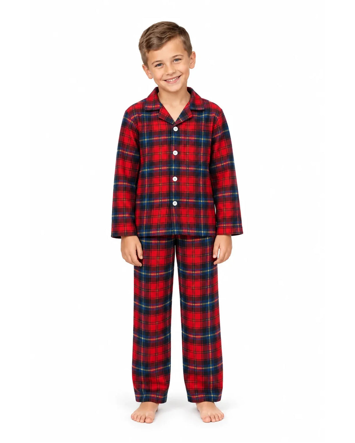 Boy wearing a red and blue plaid pajama shirt and long pants on a white background.