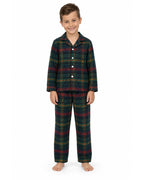 Boy wearing a dark green tartan pajama shirt and long pants on a white background.
