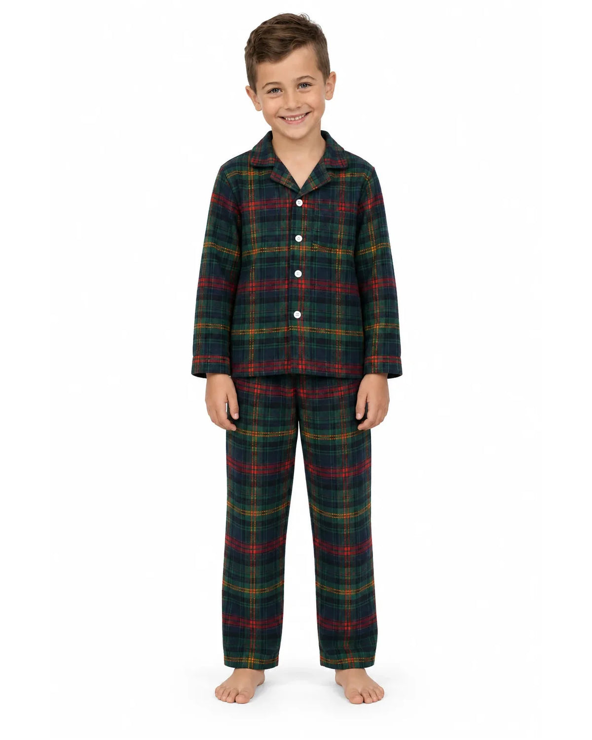 Boy wearing a dark green tartan pajama shirt and long pants on a white background.