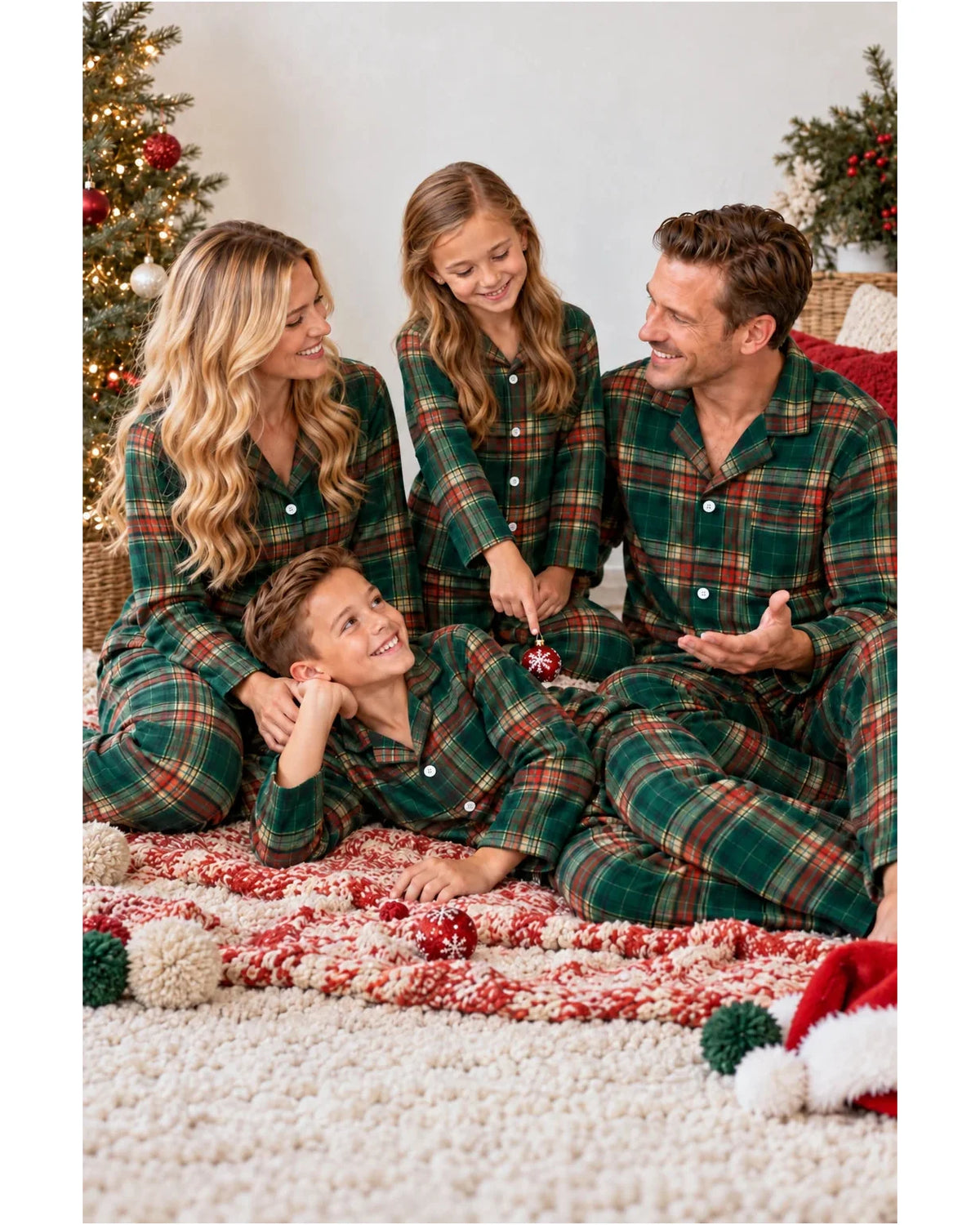 Family seated on a bed wearing matching light green tartan pajama shirts and pants.