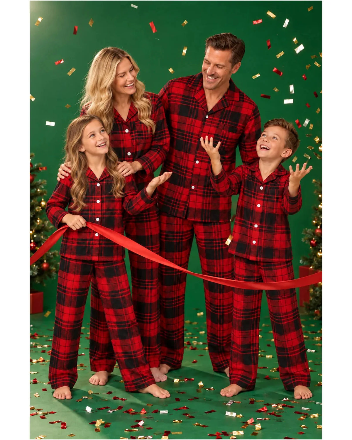 Family in red and black plaid pajamas holding a red ribbon against a green confetti backdrop.