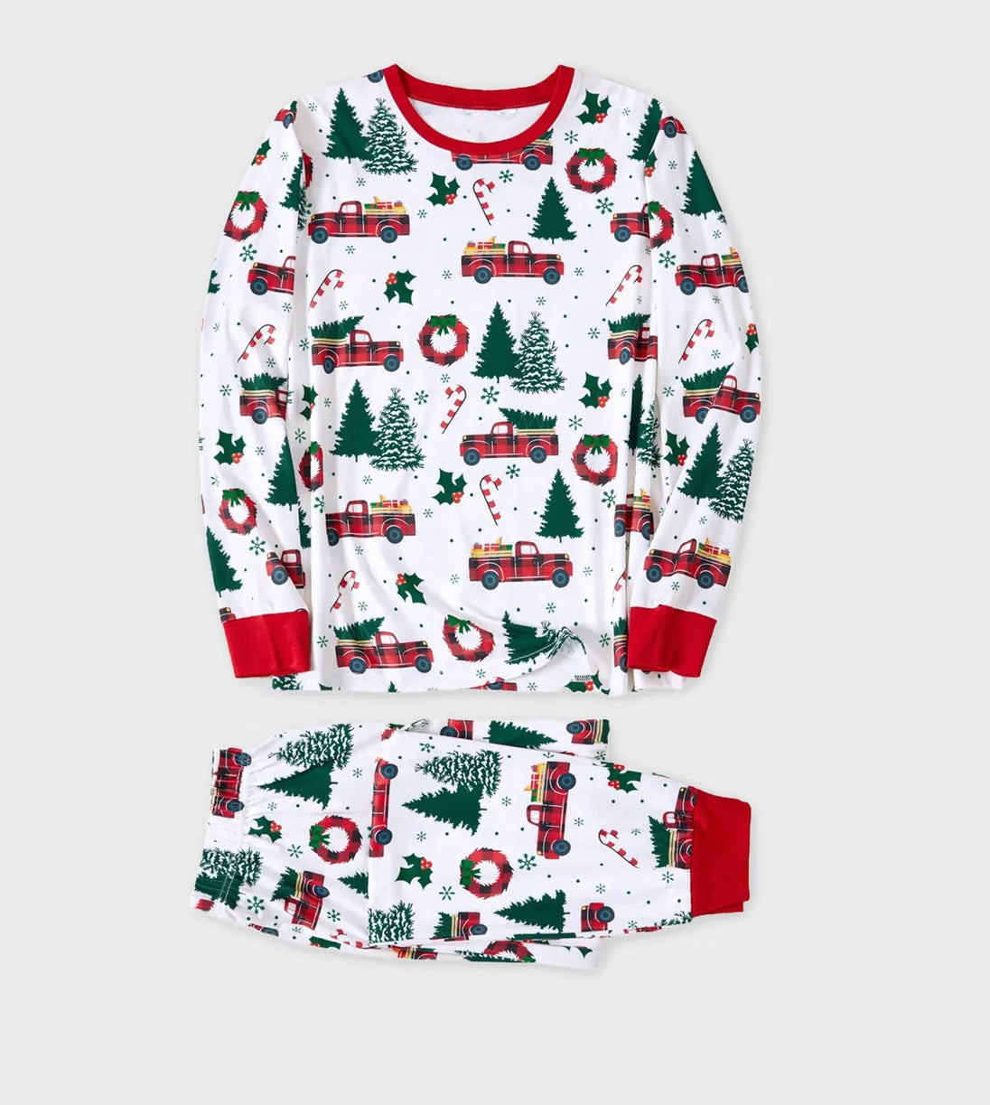 Flat lay display of a two-piece white Christmas pajama set featuring a classic red truck carrying a Christmas tree pattern.