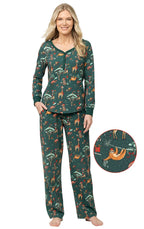 Woman wearing a dark green safari print pajama set with an inset circle highlighting the Christmas sloth pattern detail.