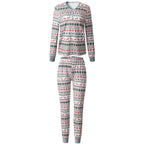 Product shot on white background of a women's two-piece Christmas pajama set featuring a buttoned Henley top and leggings in white Fair Isle print.