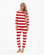 Woman modeling Christmas pajamas with wide red and white stripes, long sleeves and grey cuffs.