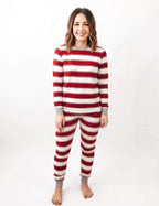 Woman wearing red and white striped Christmas pajamas with grey neckline, wrist and ankle cuffs.