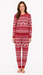 Woman wearing red Fair Isle Christmas pajamas with white trees, reindeer and snowflake patterns.