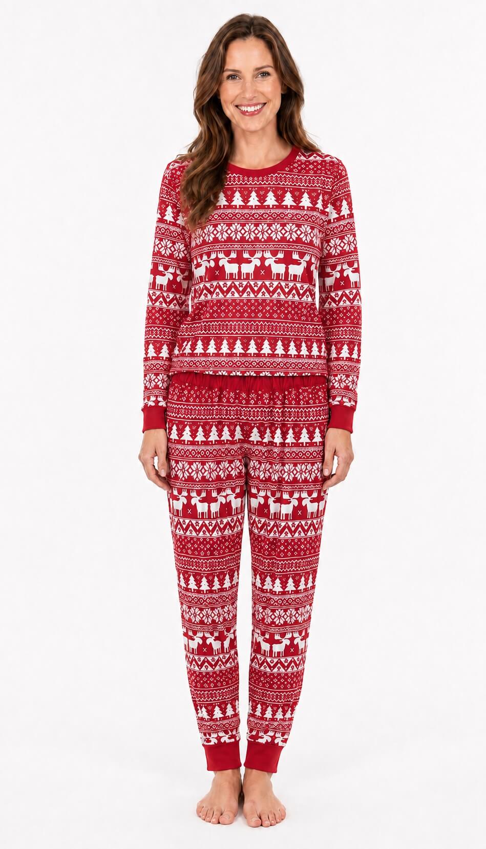 Woman wearing red Fair Isle Christmas pajamas with white trees, reindeer and snowflake patterns.