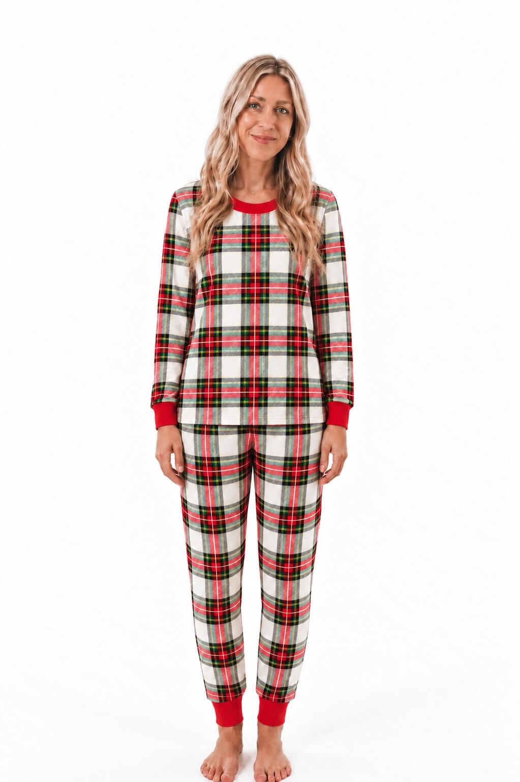Man wearing red, white and black plaid Christmas pajamas with long sleeves and red ribbed cuffs.
