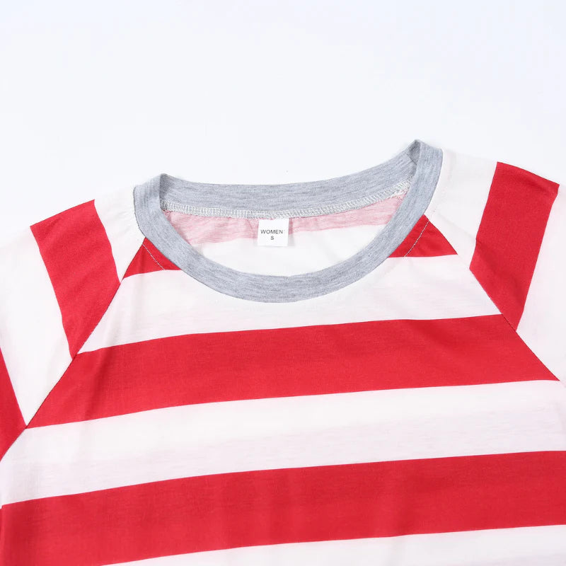 Detailed shot of a women's red and white candy cane striped pajama top showing a comfortable grey ribbed neckline and size tag.