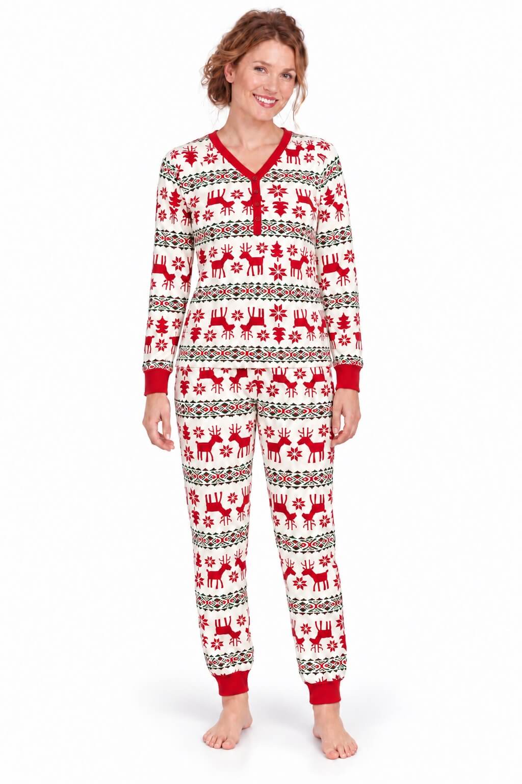 Woman wearing white Christmas pajamas with red reindeer, snowflakes, red cuffs and a buttoned V-neck.