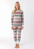 Woman modeling light grey Christmas pajamas with red reindeer bands, green tree rows and white cuffs.