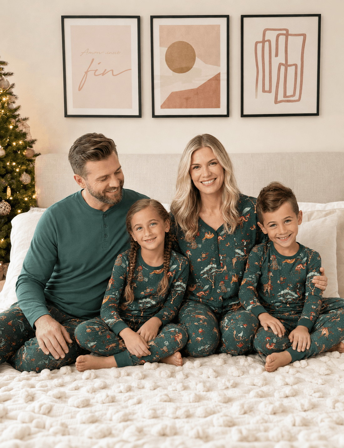 Family sitting on a bed in teal animal-print pajamas beside a Christmas tree, with dad in a solid teal top.